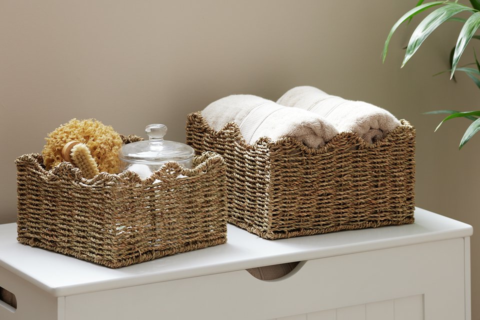 Towels and other small items placed in Habitat pack of 2 Seagrass Wave storage baskets.
